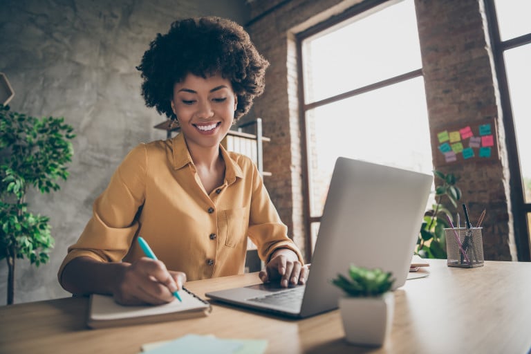 3 Simple Steps For Creating Your Monthly Marketing Strategy Image of woman sitting at desk writing